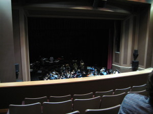 Image from a High School project, designed without a theatre consultant.  The planned 42-inch top pipe was not installed at the balcony and would have made views even worse.  As it is, no one in the balcony can see the front of the stage.