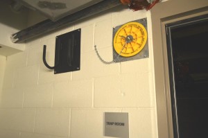 Cable Pass (yellow cap with chain) and hinged J-Hooks along the top of a corridor, leading into a Trap Room.  Photo by Paul G. Sanow, ASTC